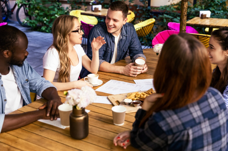 Local community search trends showing people talking and sharing food at a local café.